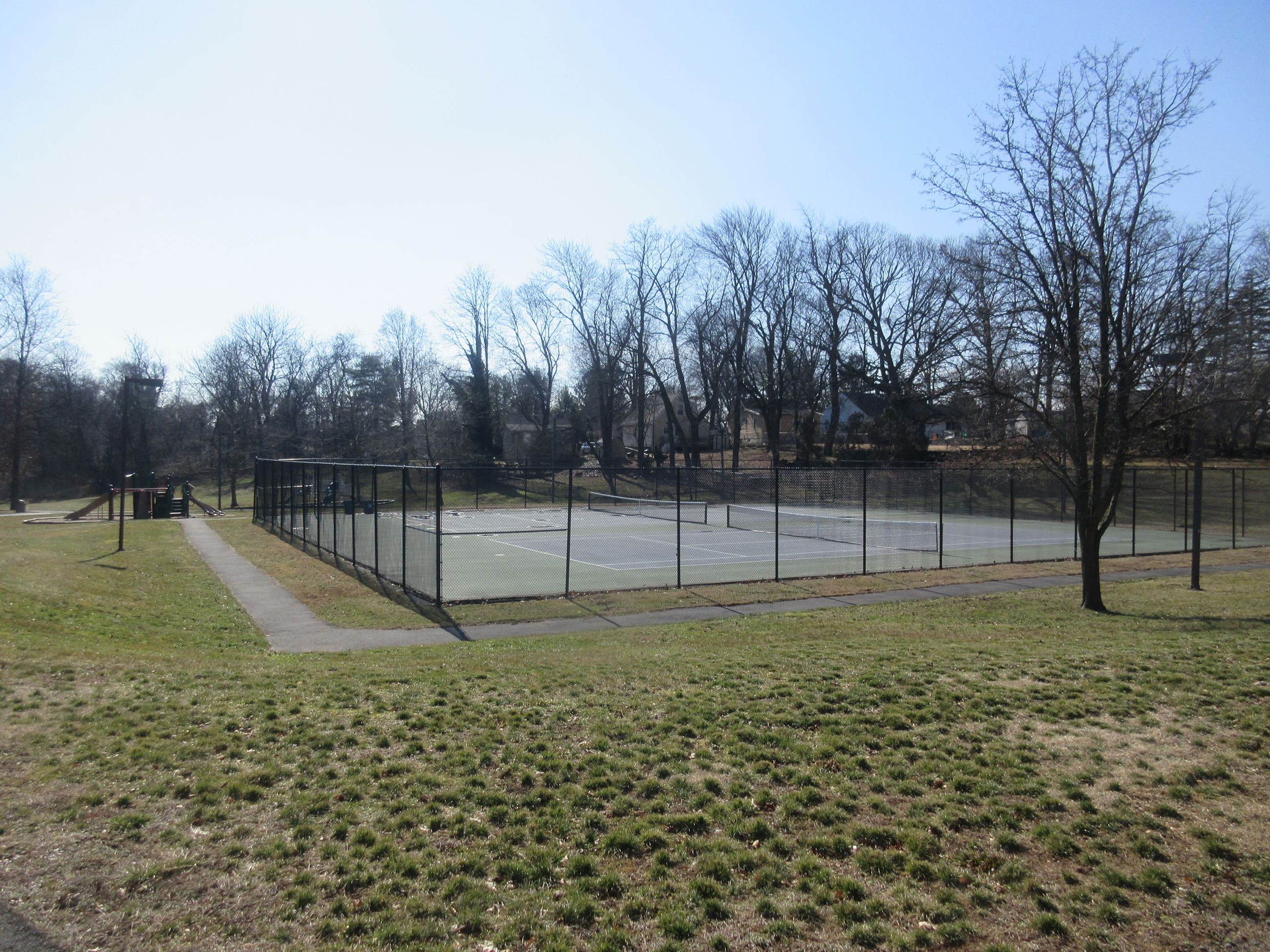 View from the main path of the fountain, tennis courts, and activity center - Sharps Lane Park.