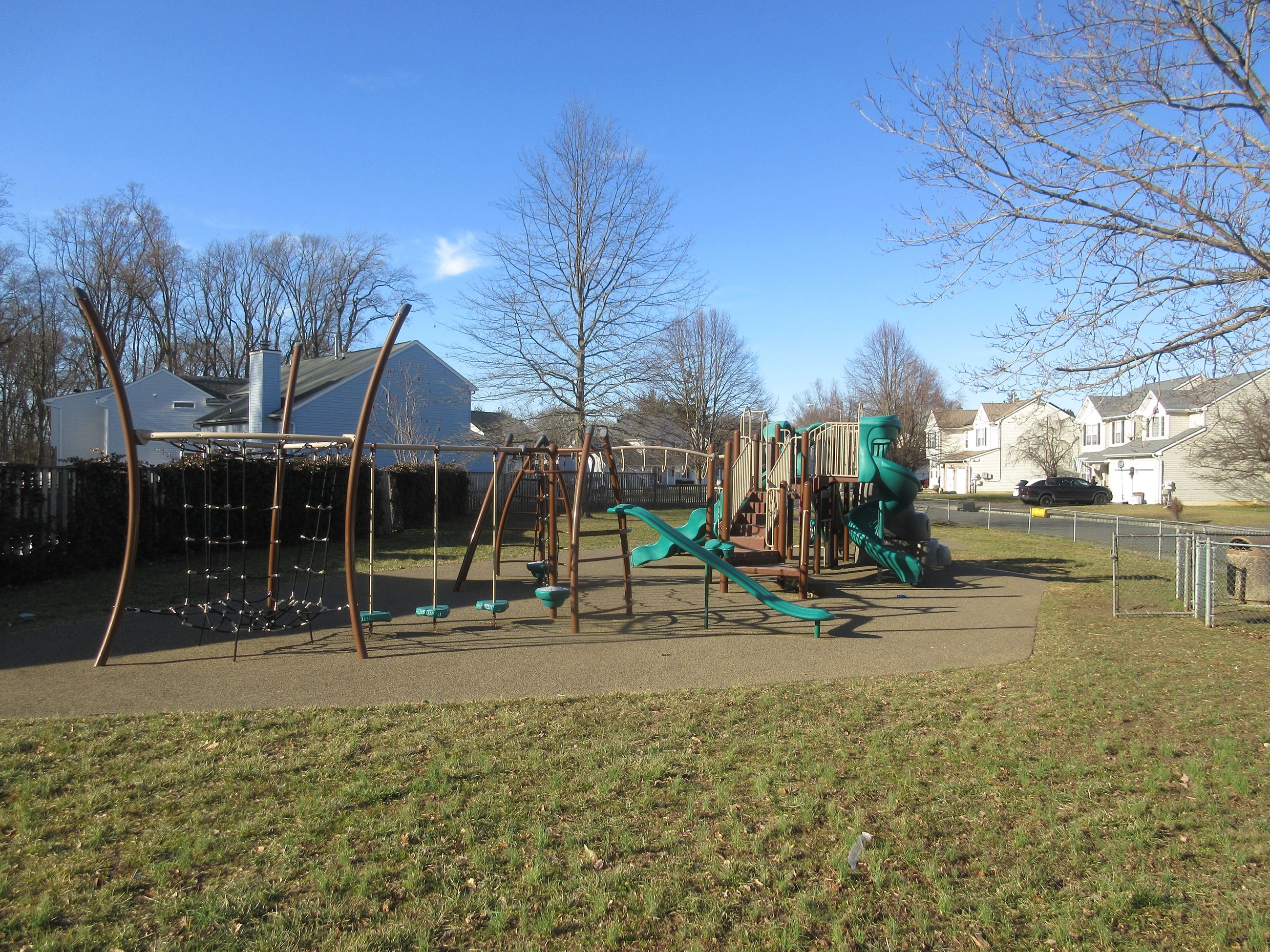 Fenceline view of the Kristopher Drive tot lot.