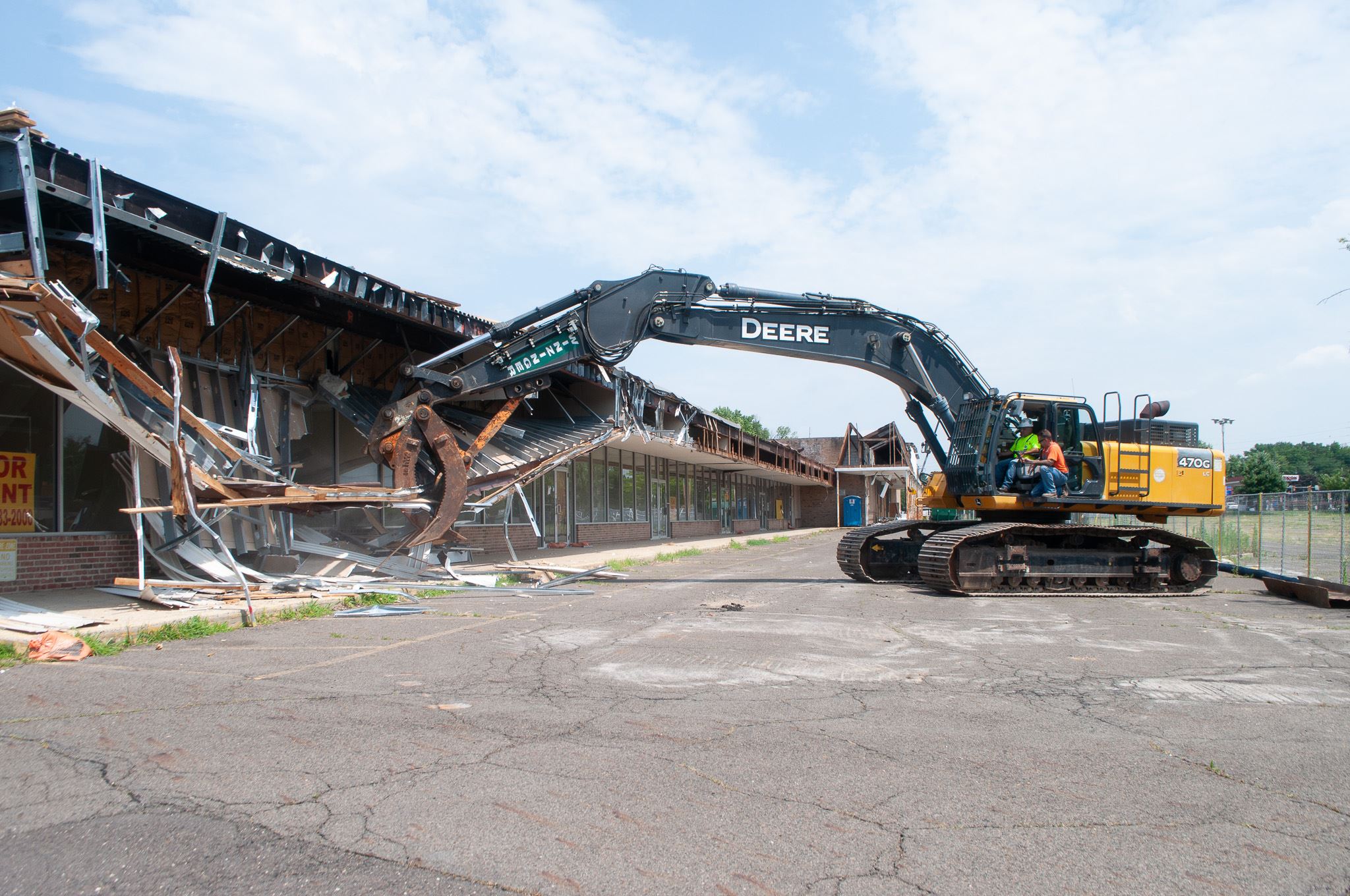 Construction equipment tearing down building