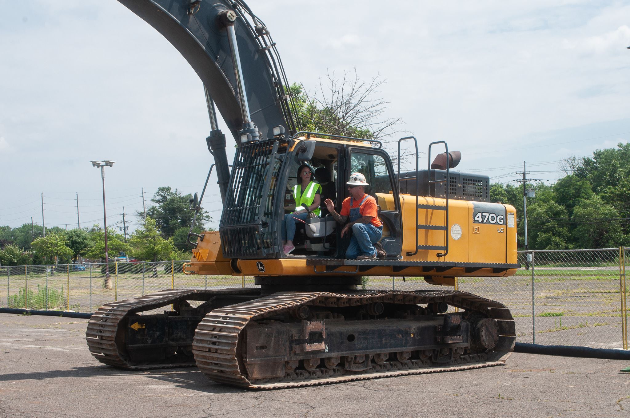 Employees operating construction equipment